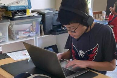 Freshman Johnathan Lee works at his computer during virtual learning.