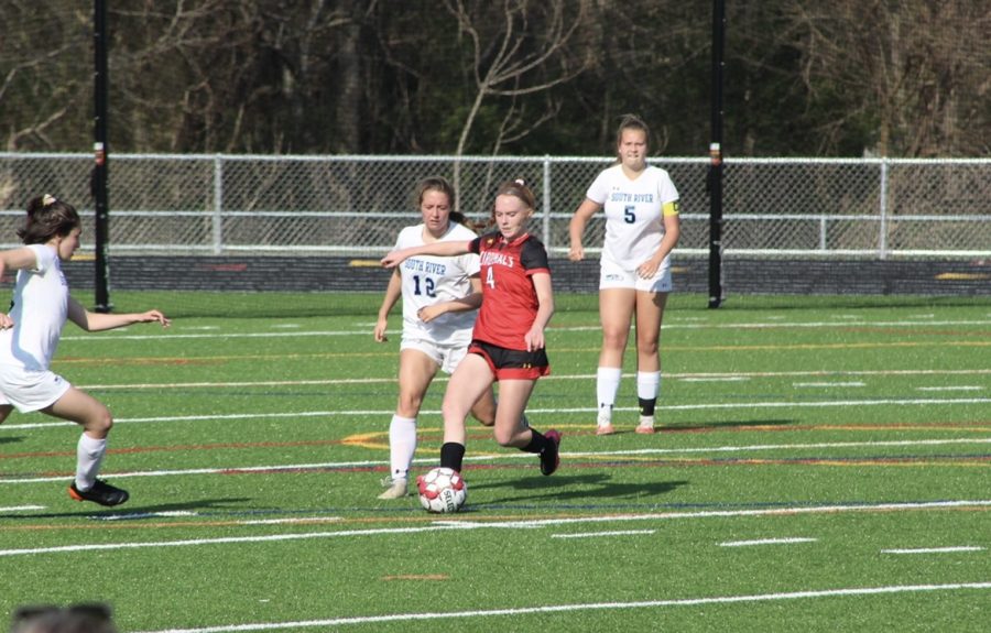 Sophomore Meghan Piazza protecting the ball from South Rivers defense.