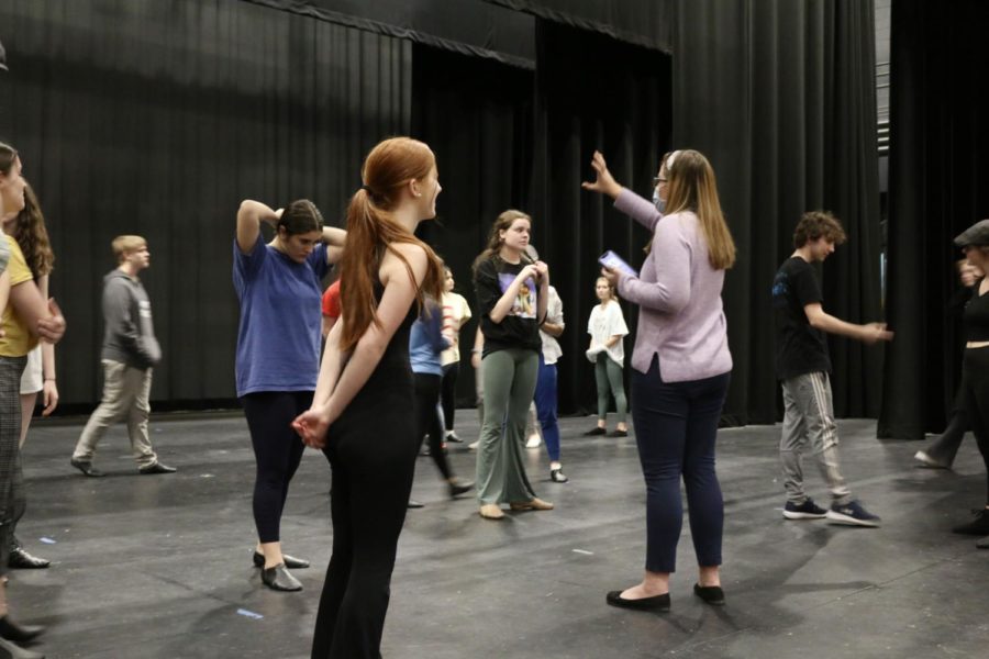 Ms. Caitlyn Connolly works with students to rehearse the musical.