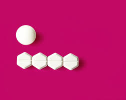 a pink background with mifepristone pills